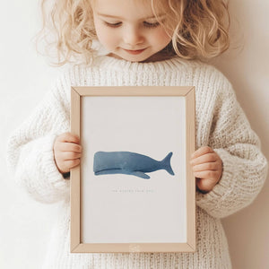 Minimalist blue whale print with the phrase 'we whaley love you,' ideal for nursery or coastal decor.